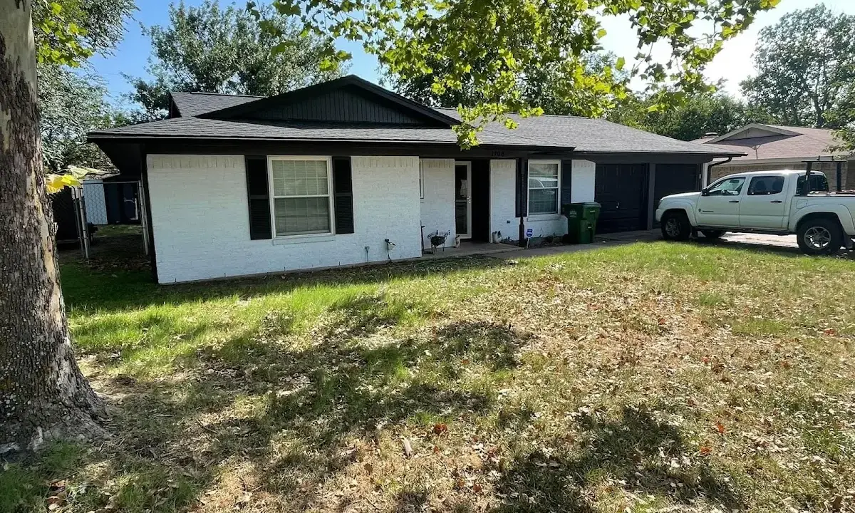 Professional roofing crew working on a residential roof in College Place